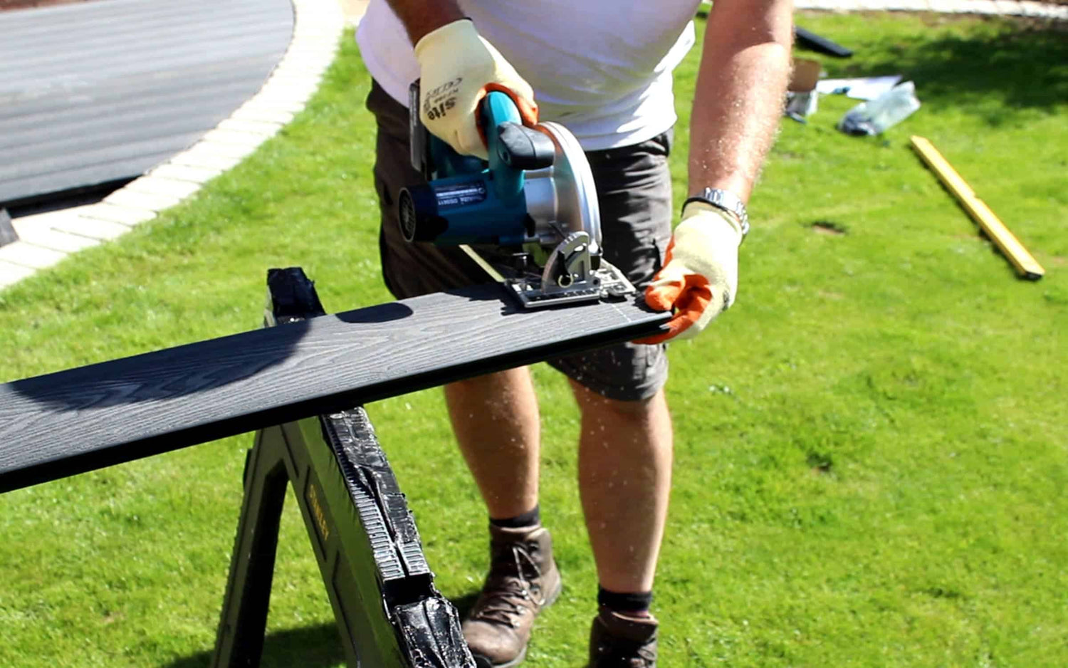 Approved NeoTimber installer sawing composite deck.