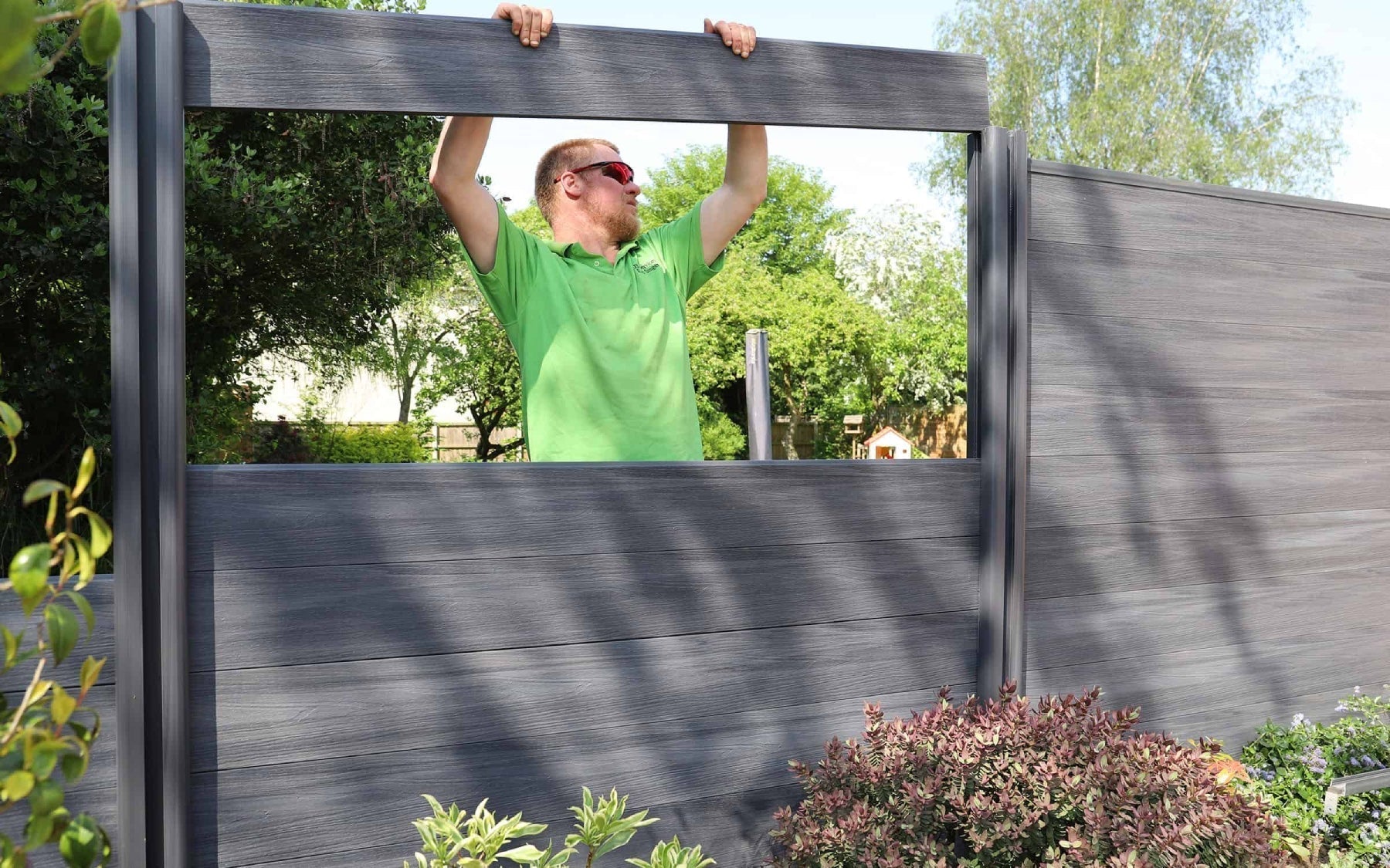 NeoTimber fence panels being fitted by an installer.