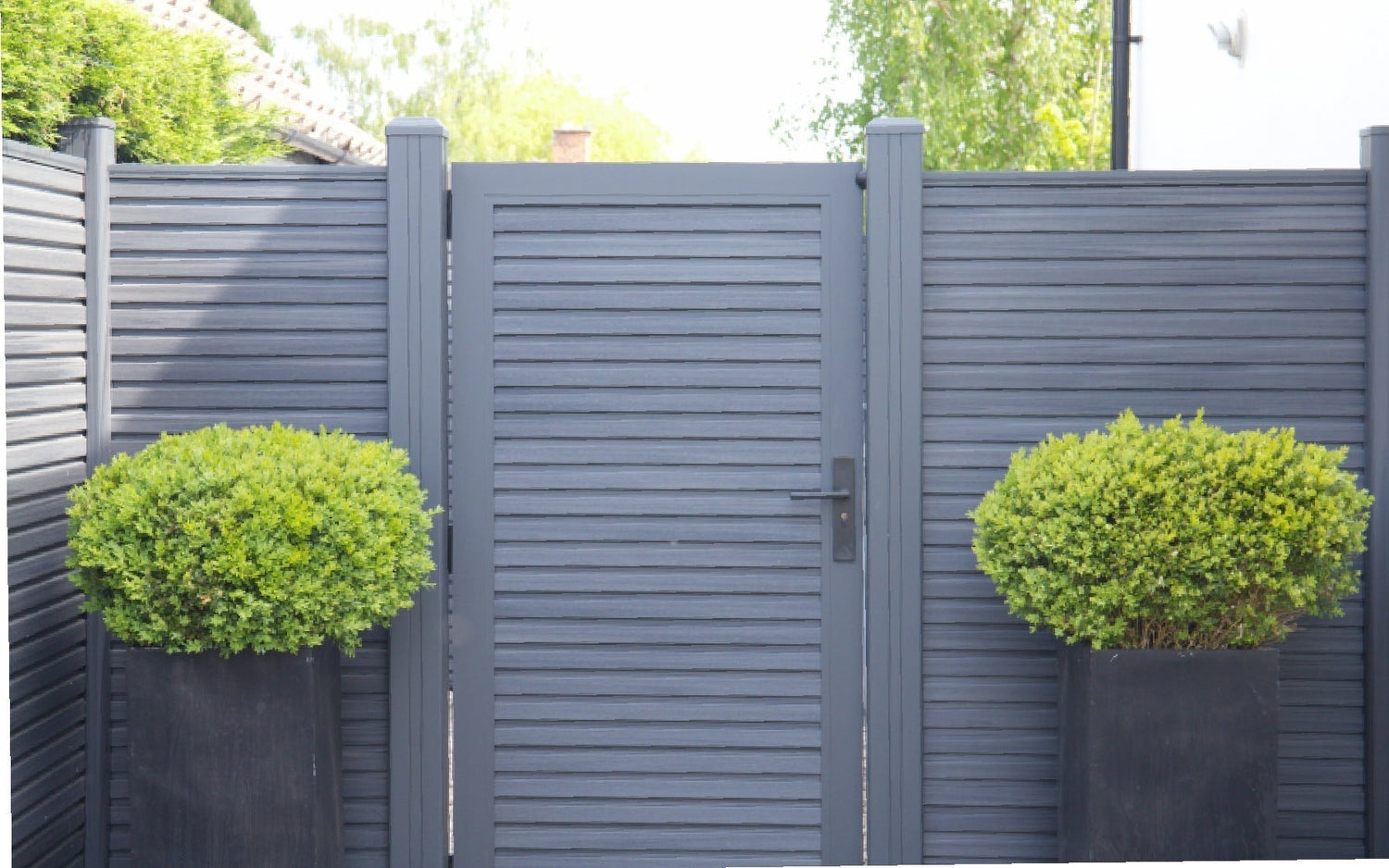 NeoTimber slatted composite fencing with gate.