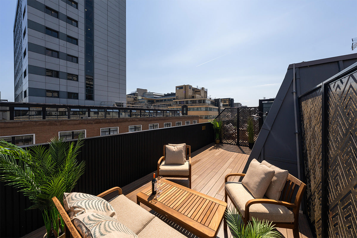 Rooftop deck with outdoor furniture and greenery