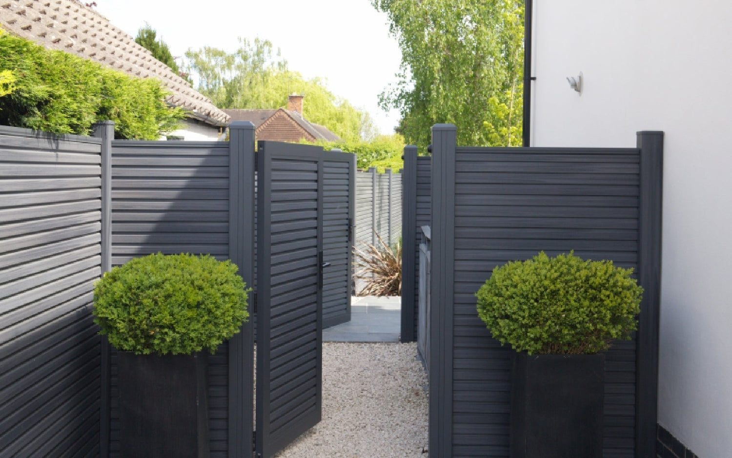 NeoTimber fencing and gates leading to fenced garden. 