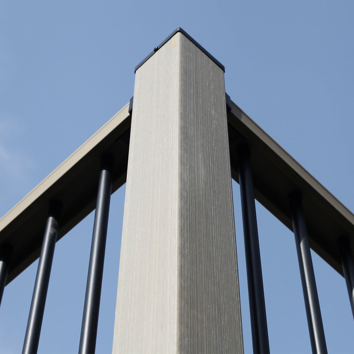composite post pillar with metal railing against a clear blue sky