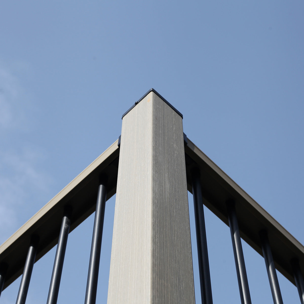 composite post with 90 degree metal railing against a blue sky