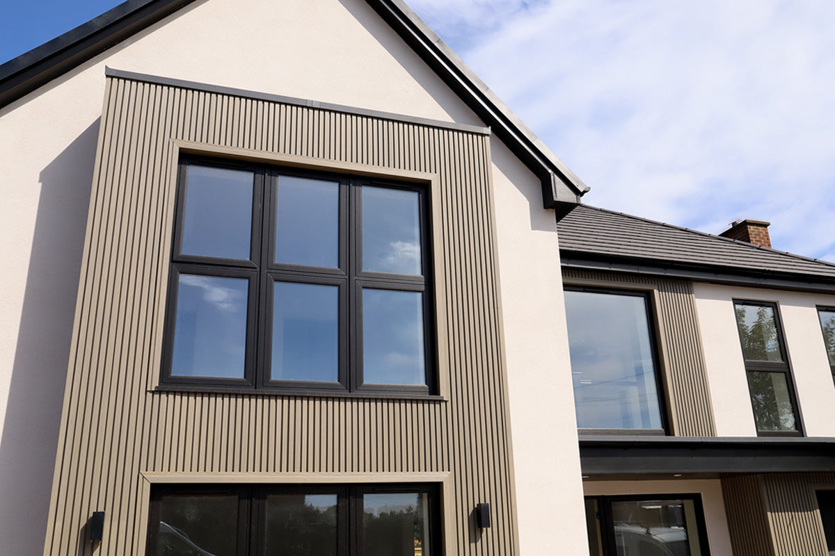 neotimber slatted antique composite cladding installed onto a new build modern home with white render