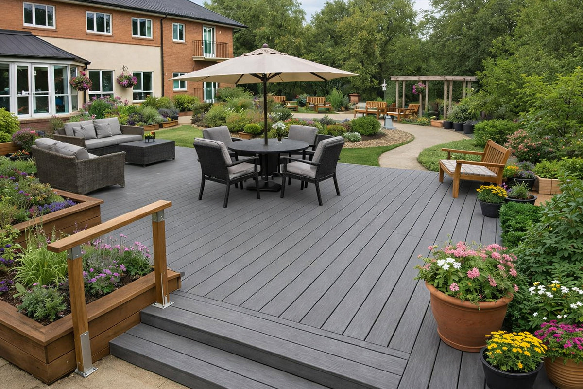 Grey composite decking installed into a care home outdoor area with planters
